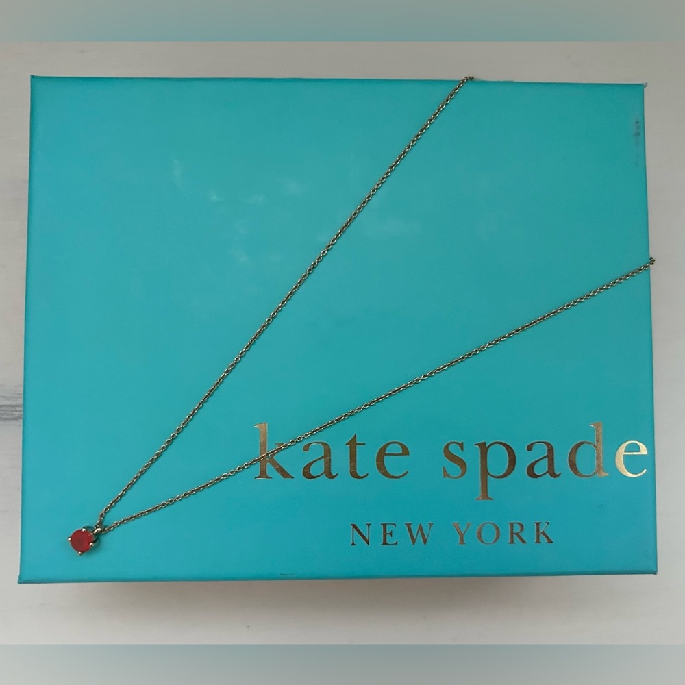 Kate Spade gold-tone necklace with pink stone charm